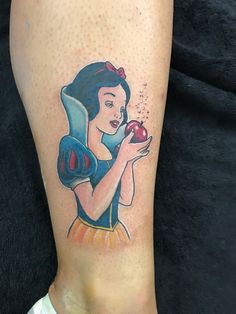 snow holding an apple tattoo on the leg