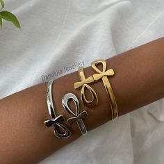 "Ankh Bangle - Gold/Silver The Ankh or also known as The Key of Life is an ancient Egyptian symbol that dates back to the early dynastic period. The first \"cross\". It symbolises life and is originally based on the feminine principals of nature, spirituality and peace. The most sacred symbol of ancient Egypt. It is an amulet for spiritual healing. Also worn for goodluck and to protect against bad energies 🖤 Fits any size arms. Open the two ankhs and place wrist in between for easy access. Made from copper and silver/gold plated. (click this link for tips on how to maintain your jewellery for as long as possible Www.Damilolajewellery.co.uk/pages/jewellery-care)" Silver Cross Bracelet, Spiritual Style, Spiritual Silver Cross Bracelet, Silver Cross Jewelry For Ceremonial Occasions, Silver Byzantine Jewelry For Ceremonies, Ceremonial Silver Cross Jewelry, Silver Byzantine Ceremonial Jewelry, Ceremonial Byzantine Silver Jewelry, Nature Spirituality, Key Of Life