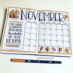 an open planner with the words november written on it and a pencil next to it