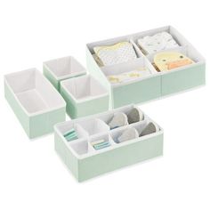 three boxes with baby items in them on a white background