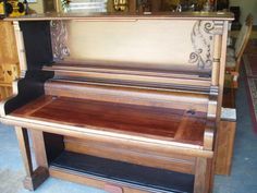 an old piano sitting on top of a wooden table