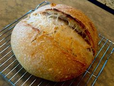 a loaf of bread sitting on top of a cooling rack