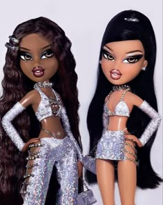 two dolls are dressed in silver sequins