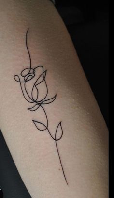 a woman's arm with a tattoo on it that has a flower in the middle