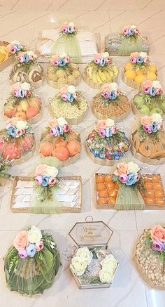 a table topped with lots of trays filled with different types of foods and flowers