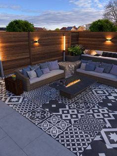 an outdoor living area with couches and fire pit