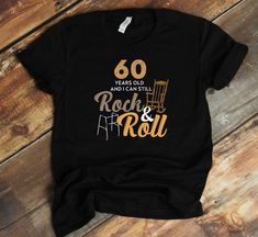 a black t - shirt that says 60 years old and not can still rock and roll