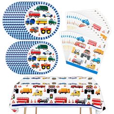 a table topped with plates and napkins covered in construction vehicles