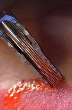 a close up view of a person's eye with an orange substance on it