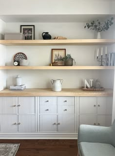 a living room with some shelves and chairs