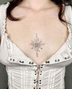 a woman's chest with a star tattoo on her left side and an arrow in the middle