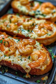 two pieces of bread topped with shrimp and cheese