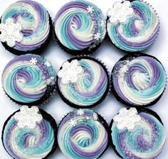 cupcakes decorated with blue, purple and white frosting