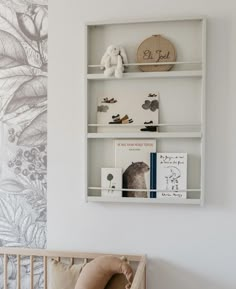 a baby's room with a crib and bookshelf