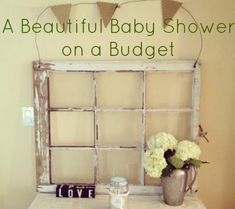 a beautiful baby shower on a budget with flowers in a vase and an old window