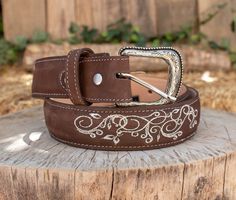 -Silver etched buckle -Floral embroidery -Genuine leather -COLOR BROWN Western Style Engraved Belt For Ranch, Western Style Engraved Belts For Rodeo, Western Engraved Belts For Rodeo, Engraved Western Belt For Ranch, Western Engraved Adjustable Belt, Western Style Engraved Adjustable Belts, Western Adjustable Engraved Belts, Western Style Adjustable Engraved Belts, Western Silver Embroidered Belt