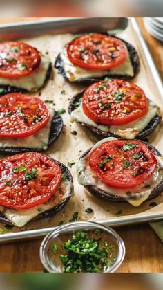 a pan filled with sliced tomatoes on top of a wooden table