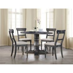 a dining table with four chairs around it