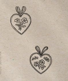 two hearts with bows and flowers on them are drawn in black ink, sitting next to each other