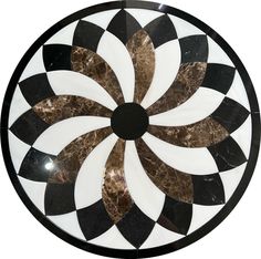 a black and white marble plate with an intricate design on the top that looks like a flower