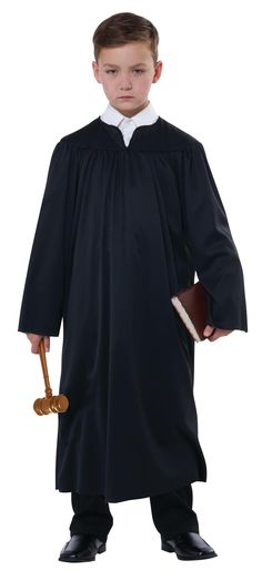 a young boy dressed in a judge's robe and holding a gavel