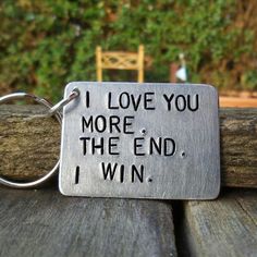 a metal keychain that says i love you more than the end, i win