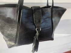 "Handbag Claudia Firenze black leather tote 11 1/2\" L 15 1/2\" L lying flat 9 1/2\" H 4:d 10 1/2\" shoulder drop zip closure at top and tab fold over with snap and tassel on end black fabric lining and one internal zip pocket Made in Italy Bag is in excellent condition" Green Leather Handbag, Black Leather Tote, Leather Handbags Tote, Black Leather Handbags, Tote Handbag, Satchel Handbags, Red Coral, Green Leather, Leather Satchel