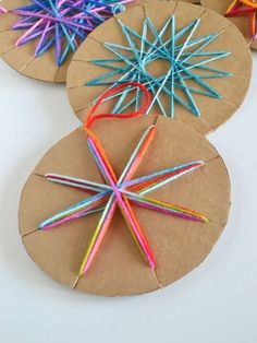 these paper plate crafts are made with colored pencils and brown cardboard, which is shaped like a snowflake