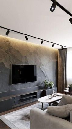 a living room with couches and a flat screen tv mounted to the side of a wall