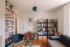 a living room filled with furniture and lots of books