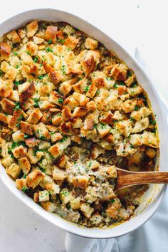 a casserole dish filled with stuffing and topped with parsley