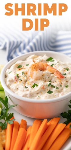 shrimp dip with carrots, celery and crackers on a white plate