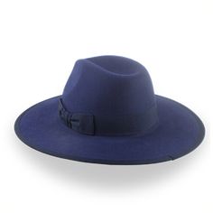 Description Materials Craftsmanship Hat Care Shipping Returns Product Description Bold Navy Blue Flat Brim Fedora for Contemporary Style Introducing the Taylor, a navy blue flat brim fedora that redefines modern elegance. Masterfully crafted from premium rabbit fur felt, this hat features a striking 4 1/2" center-dent crown and a substantial 3 5/8" steel-wired bound flat brim, creating a bold silhouette that demands attention. Custom-made to your exact measurements, the Taylor offers unparallele Mens Felt Hats, Spanish Hat, Homburg Hat, 1940 Style, Outdoor Hut, Gambler Hat, Navy Blue Flats, Mens Hats Fashion, Fedora Hat Men