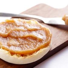 a wooden cutting board topped with pastry on top of a white table