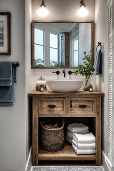 a bathroom sink sitting under a mirror next to a wooden cabinet with drawers and baskets