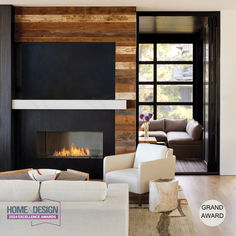 a modern living room with wood paneling and white furniture in front of a fireplace