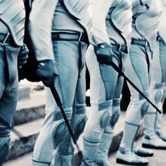 a group of men in uniform standing next to each other with their dogs on leashes