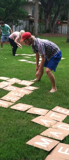 two children playing with wooden blocks in the grass