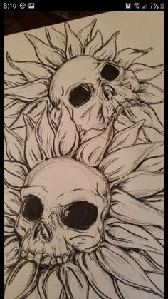 two skulls with sunflowers on their heads are shown in black and white ink