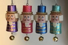 three nutcrackers are hanging from the wall with bells attached to each ornament