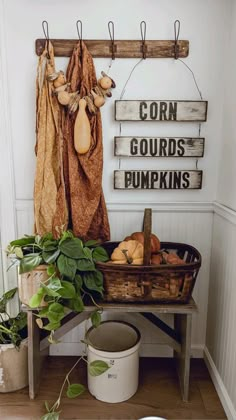 a wooden sign that says corn, gourds, pumpkins and other things