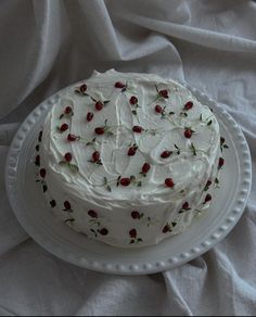 a cake with white frosting and strawberries on it