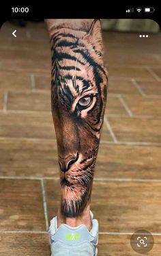 a man's leg with a tiger tattoo on it, and the image of a tiger