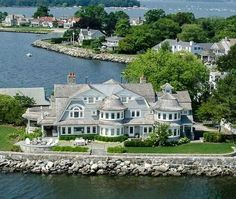 an aerial view of a large house on the water