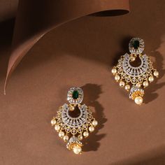 Description Adorned with shimmering CZ stones throughout and embellished with freshwater pearl drops, these timeless chandbali earrings are perfect for every occasion. Their traditional Indian design patterns exude a sense of regal sophistication. Whether paired with an ethnic Anarkali or a traditional silk saree, they add a touch of elegance and grace to any festive ensemble. Details & Specifications: Materials used: CZ Stone with White Gold Plating Weight - Earrings 20.5 gm Length - Earrings 6 White Stone Chandbali Earrings Gold, Chandbali Earrings Gold, Traditional Silk Saree, Chandbali Earrings, Indian Wedding Wear, Gold Earrings Designs, Gold Necklace Designs, Custom Earrings, Design Patterns