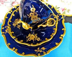 a blue and gold china dinner set on a table