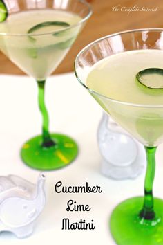 two martini glasses with cucumber lime martini in them