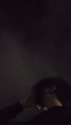 a blurry photo of a person in the dark