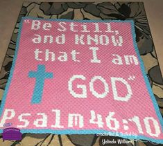 a crocheted blanket with the words i am god on it