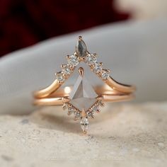 a diamond ring sitting on top of a white cloth